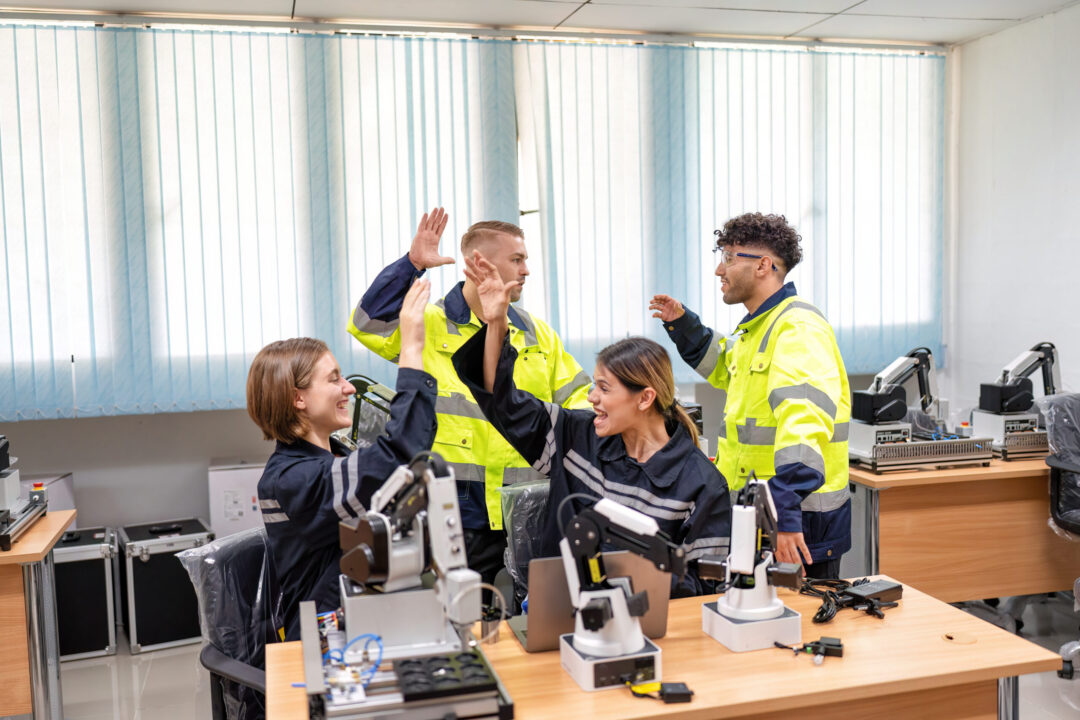 Engineering professionals celebrating a workplace achievement