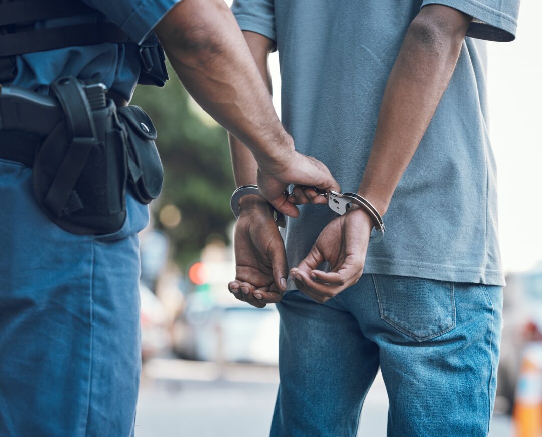 Police officer handcuffing a suspect during a criminal investigation