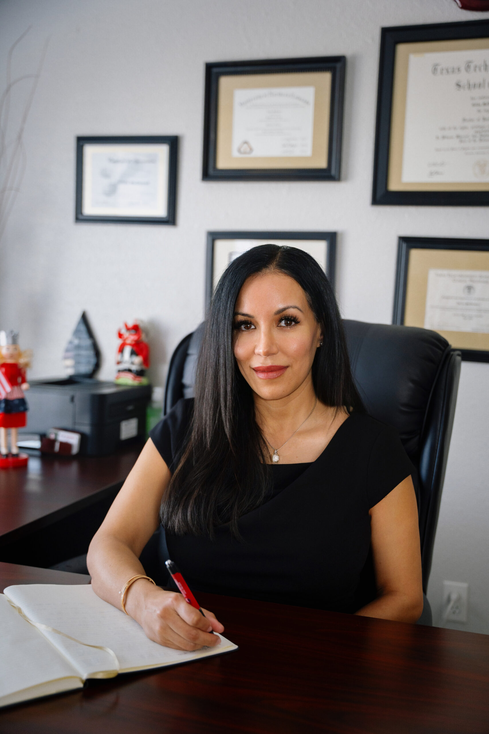 Immigration attorney Gilda McDowell seated at her office desk