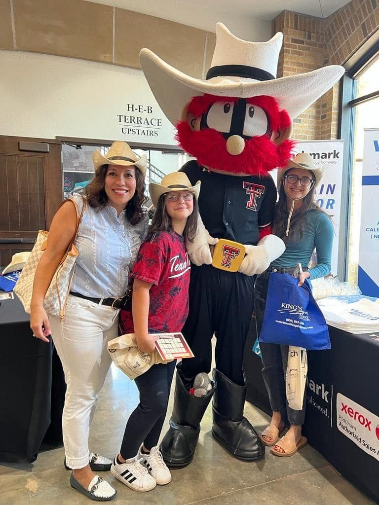 A family with Raider Red at a Lubbock business expo