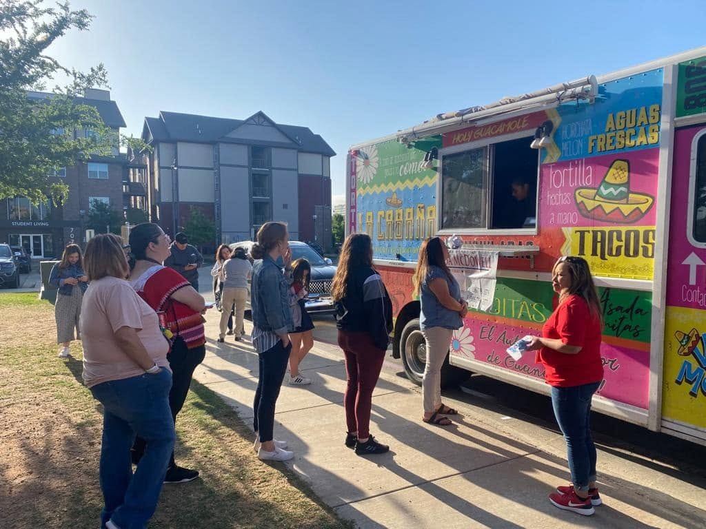 Neighbors gathered around food trucks at a community event in Lubbock
